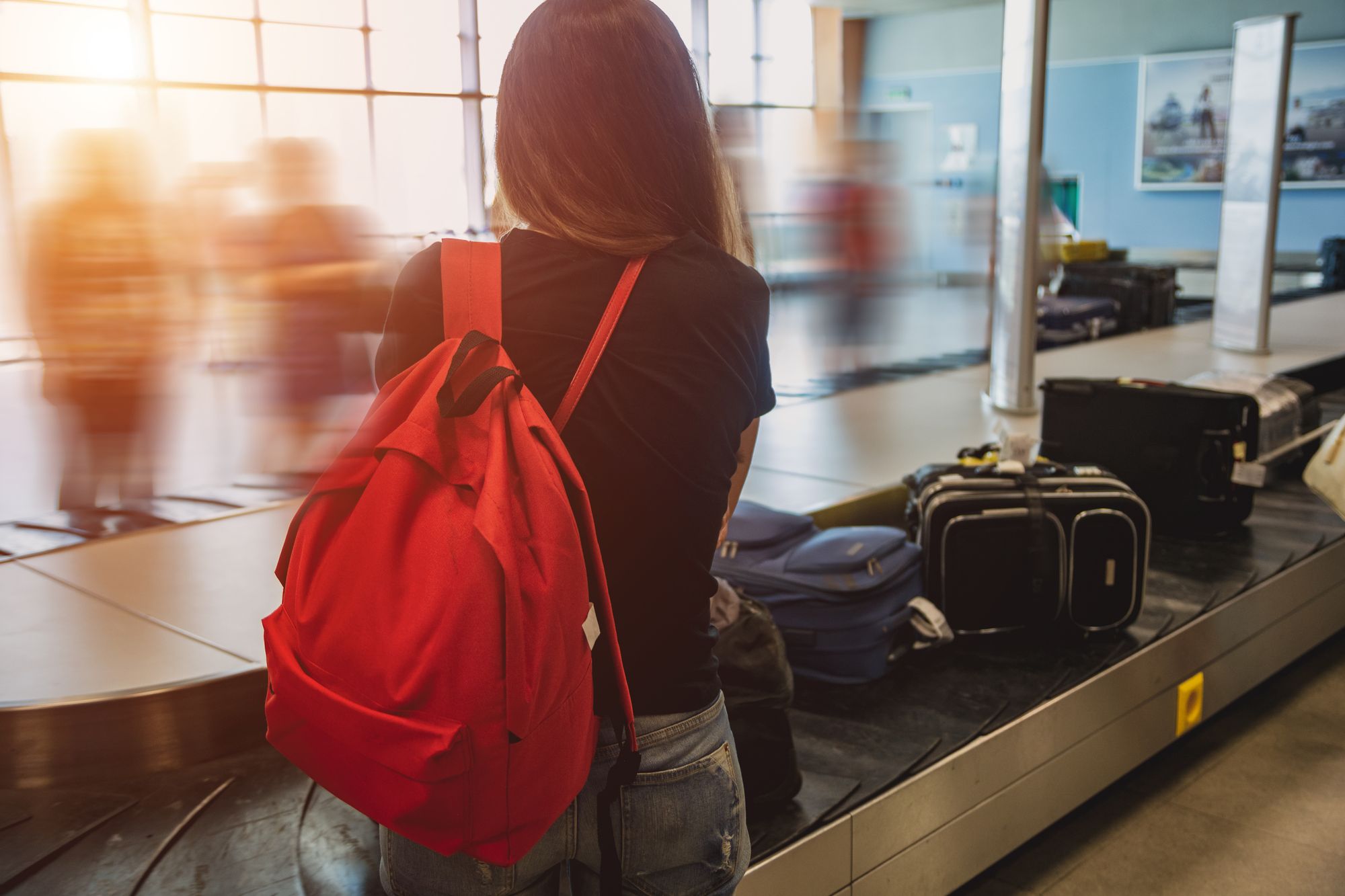 Girl waiting for her luggage at the airport