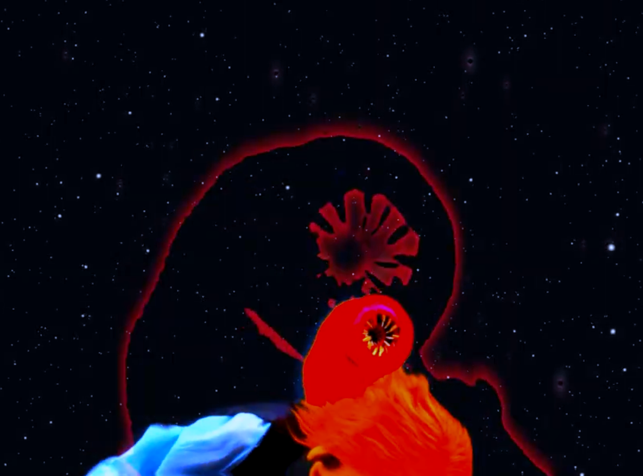 A puppet head has a galactic space worm or brain worm coming out of it. The worm is a puppet the background is space.