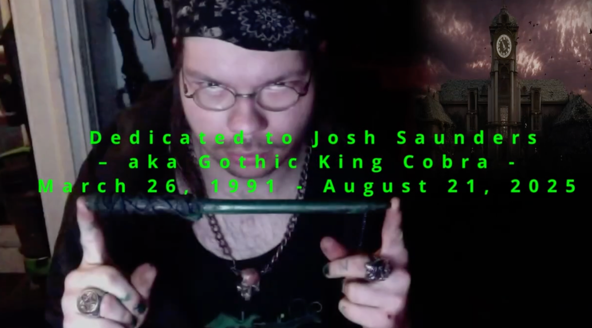 King Cobra holding a wand with a clock tower behind him and his birth and death date.