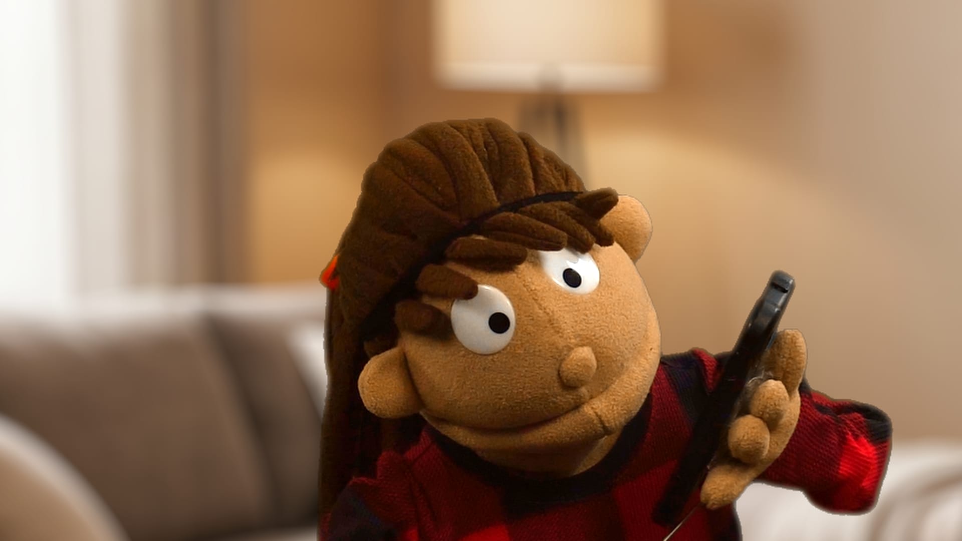 An orange-brown puppet character with wide googly eyes holding a black smartphone to its ear with a stunned, distressed expression.