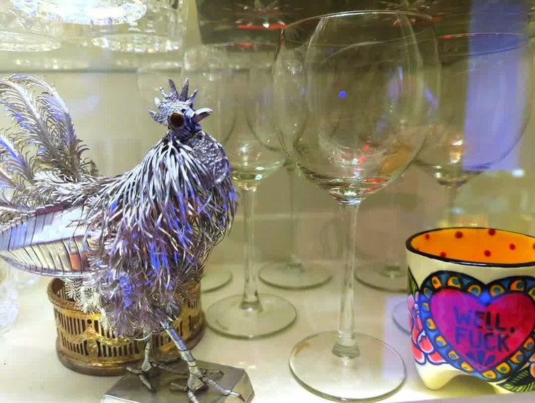 Metal rooster and cup with wine glasses