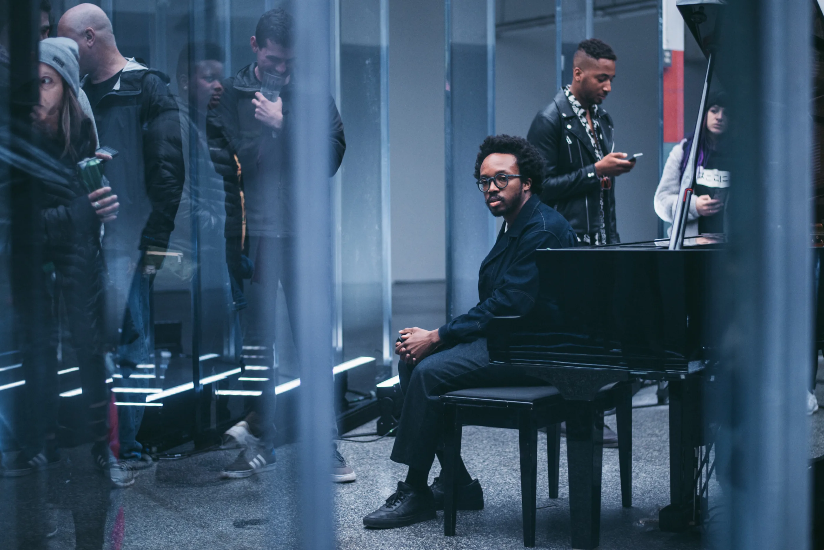Photo of a man sitting at a piano bench.
