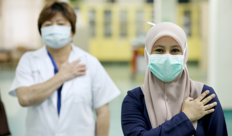 Frontliners in masks at a hospital