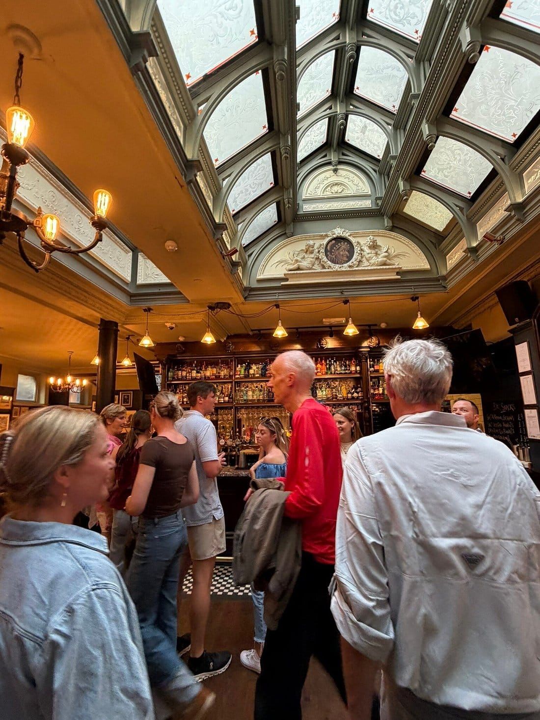A view of a quiet, sunlit Parisian café in a residential neighborhood away from major tourist landmarks.