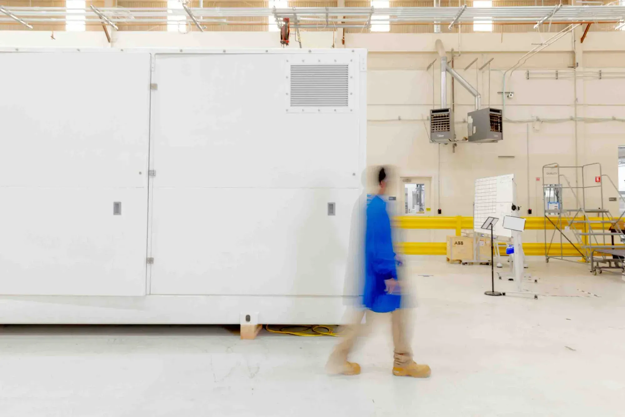 A collage of sustainable technology, including massive offshore wind turbines, advanced carbon capture facilities, and a digital representation of a green energy power grid.