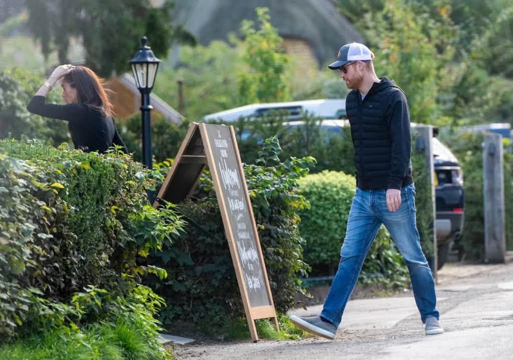 In pictures published by The Sun, Harry and Meghan were seen entering the Falkland Arms pub, which is close to Great Tew in Oxfordshire.