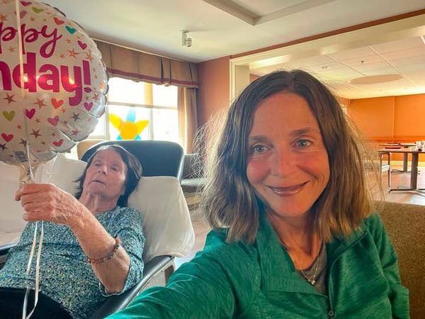 Older woman with dementia receiving support from her daughter