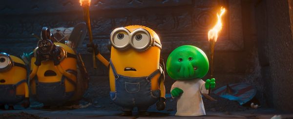 Official teaser graphic for Minions & Monsters showing a group of Minions playfully interacting with fantastical, monstrous creatures.