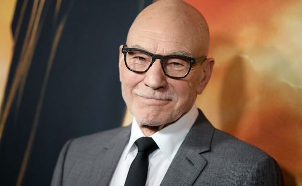 Sir Patrick Stewart attending an event, looking distinguished in a blazer, with promotional imagery of his roles as Professor X and Captain Jean-Luc Picard.