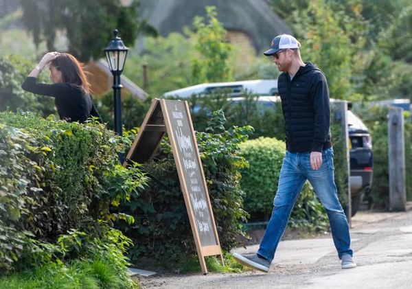 In pictures published by The Sun, Harry and Meghan were seen entering the Falkland Arms pub, which is close to Great Tew in Oxfordshire.