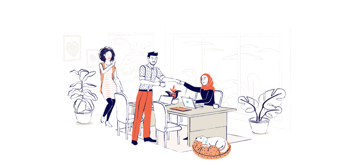 Two employees fist bump over a desk, while a third coworker and a dog watch on