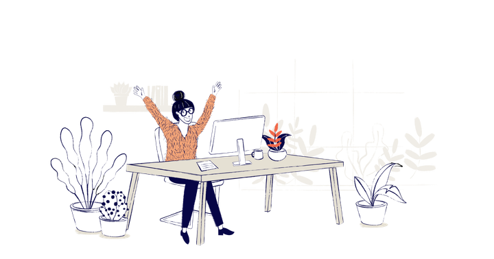 A woman sits at a desk celebrating a win, her arms are in the air and she is smiling