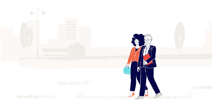 A woman and a man walking in a park. They are wearing business attire and talking.