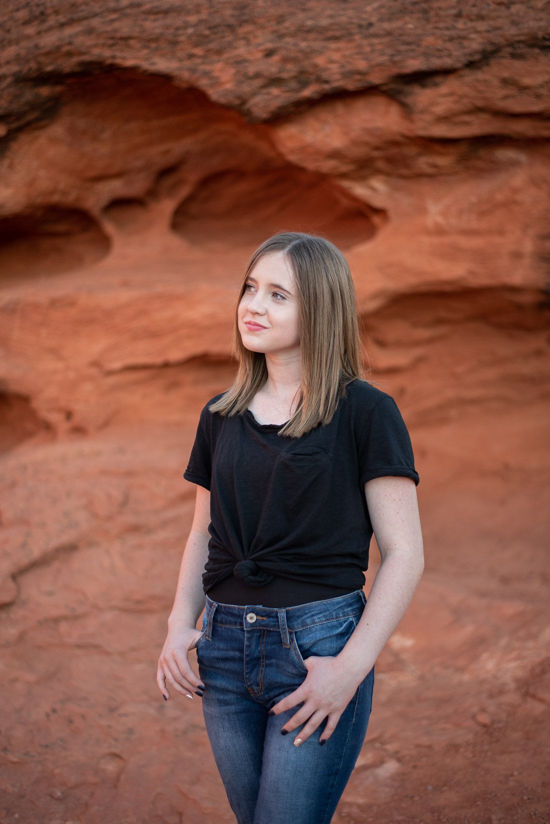 Girl with hands in her pocket looking to the side
