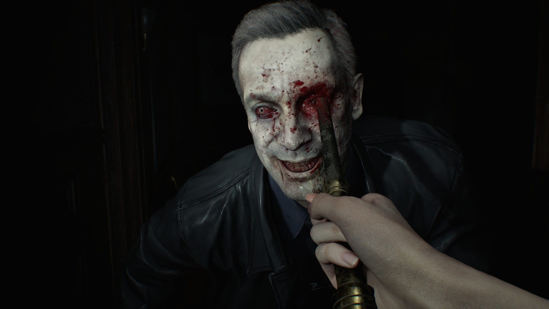 A zombie policeman smiles as he is pierced through the eye socket with a poker.