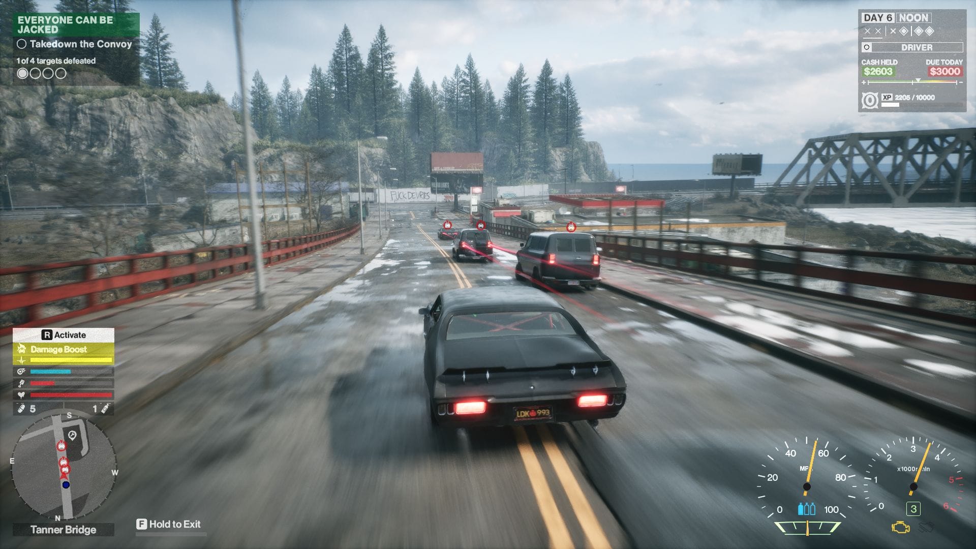 The player's car, pursuing three vans over a bridge towards a junction.
