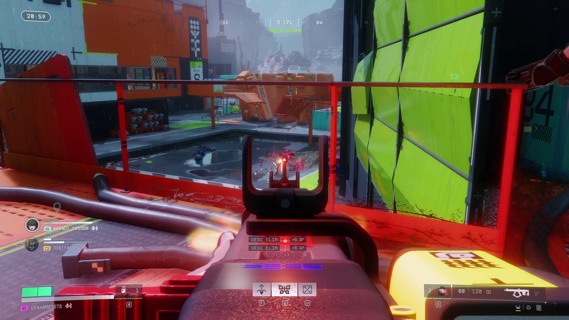 Shooting at a robot from a raised walkway. The walkway is red, and there's a bright green wall alongside.