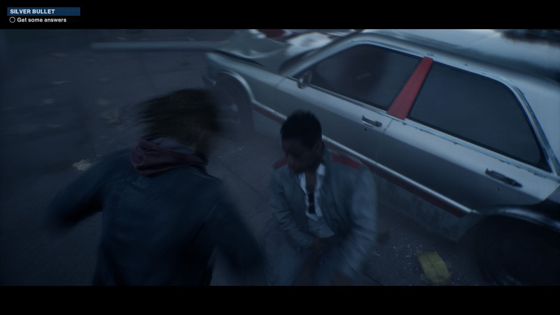A blurred image of Samson punching somebody next to a crashed car.