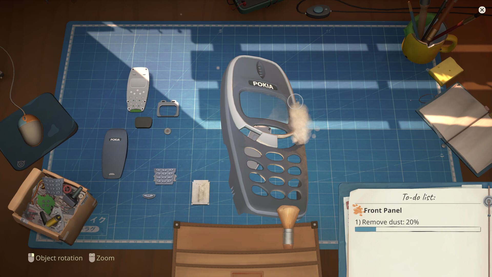 A "Pokia" branded mobile phone, that looks like an old Nokia, above a blue cutting mat.