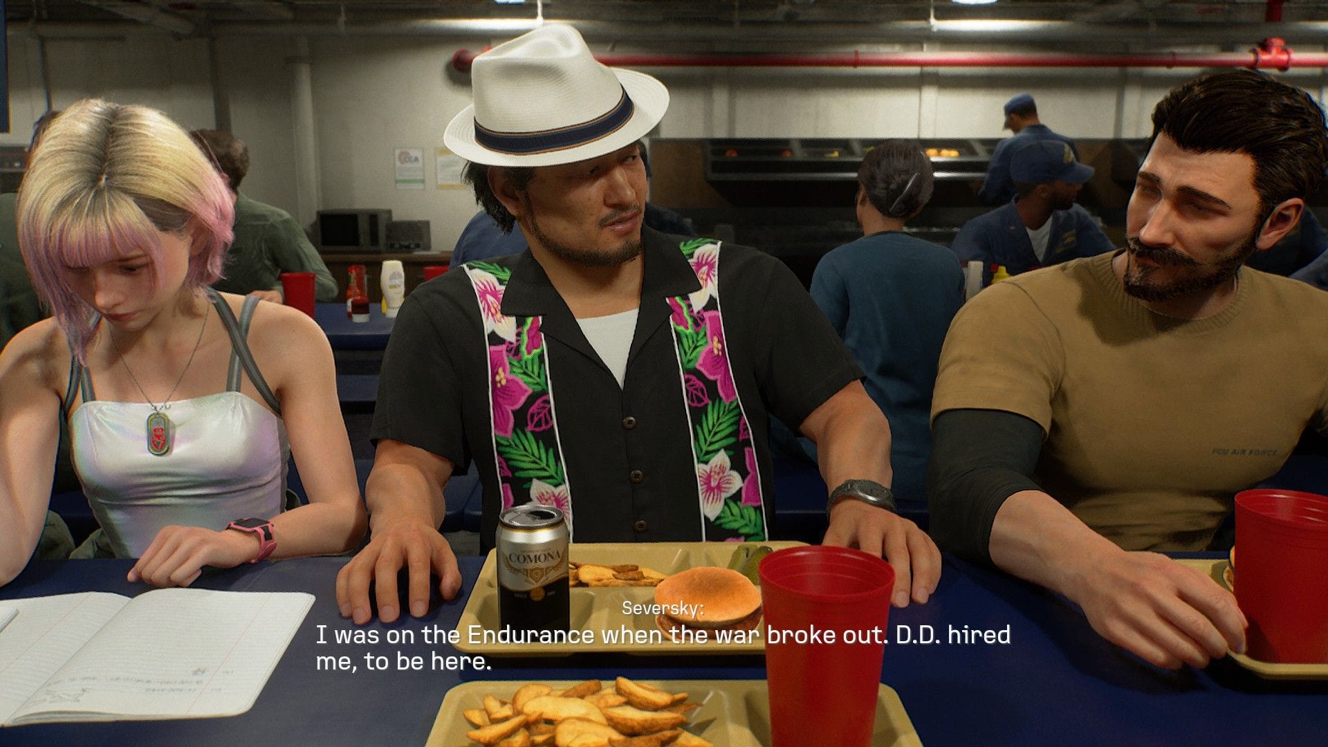 Three crewmates chat over trays of food in a ship's canteen.