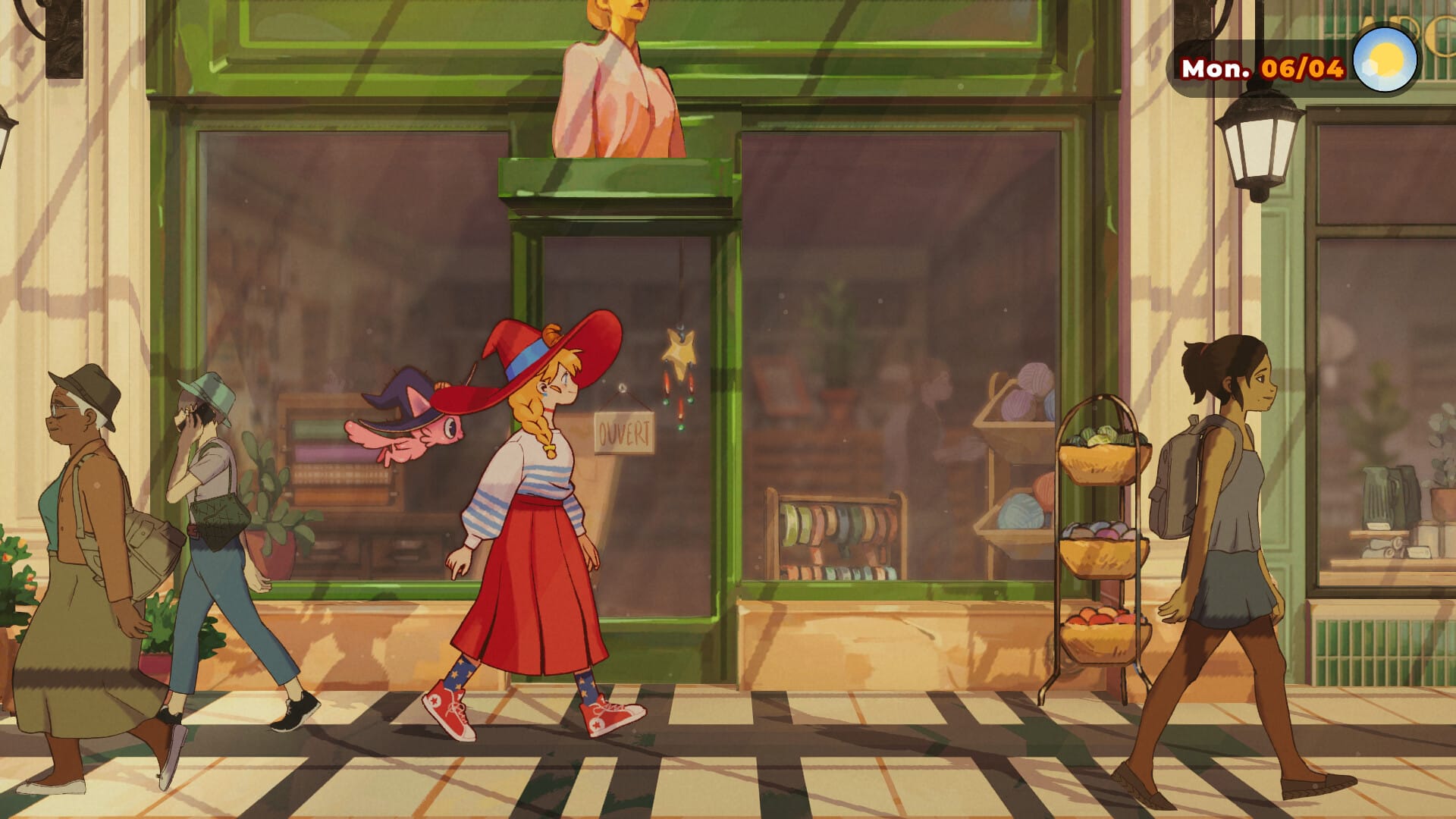 A woman with a red wide-brimmed witch's hat walks down a sunlit street, past trendy craft shops. A flying cat follows her.