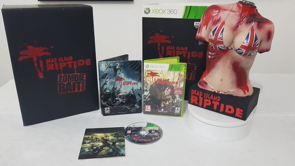 A photograph showing the contents of the Dead Island Riptide Zombie Bait Edition, including a statue of a headless, limbless female torso in a Union Jack bikini.