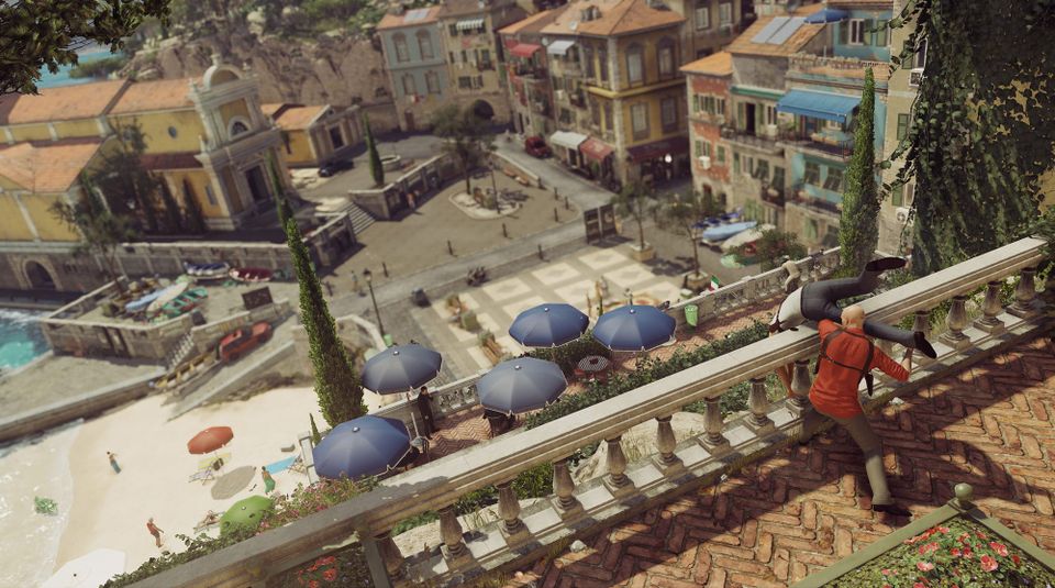 A Hitman screenshot showing Agent 47 throwing somebody off a wall overlooking a terrace.