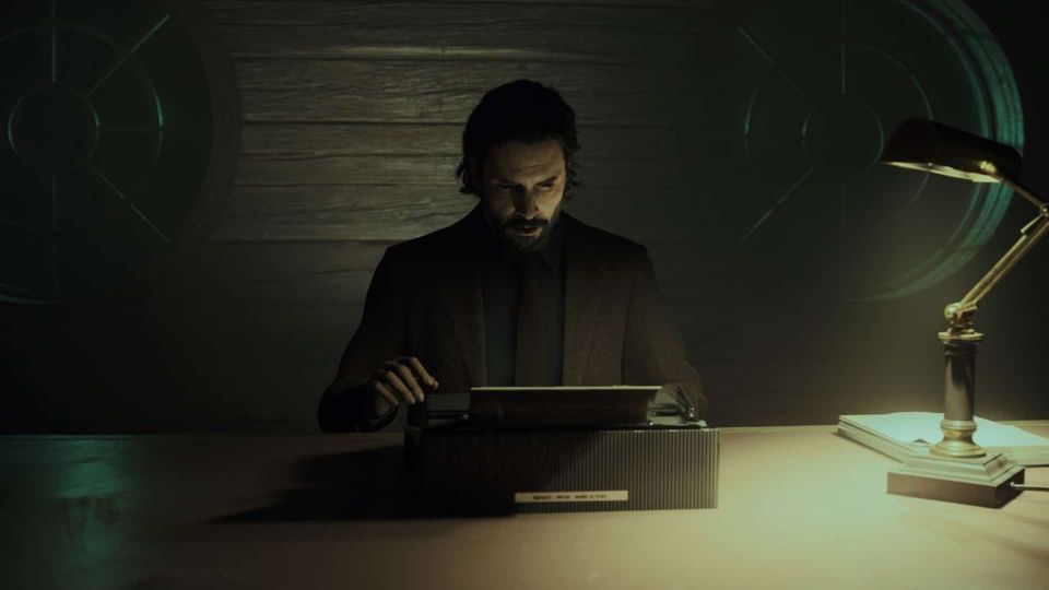 A screenshot of Alan Wake using a typewriter, in darkness illuminated by a desk lamp.
