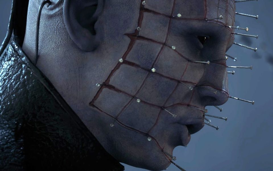 A pale man with black eyes and a face full of pins makes an "Oooh" shape with his mouth.
