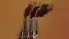In a composite image, three hand guns are lined up like smokestacks with smoke rising from them.