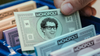 In a composite image, Mark Zuckerberg’s smiling face is seen on Monopoly money within the board game.