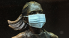 A surgical mask is placed on The "Fearless Girl" statue outside the New York Stock Exchange.