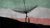 A composite image of a person on a hillside inspecting a radio transmitter overlaid by faint numbers and the colors of an Iranian flag.
