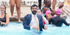 New York City Mayor Zohran Mamdani jumping into a pool.