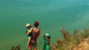 A woman and two young children look out over Lake Michigan.