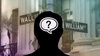 A silhouetted head is overlaid with a question mark, with the Wall Street street sign behind.