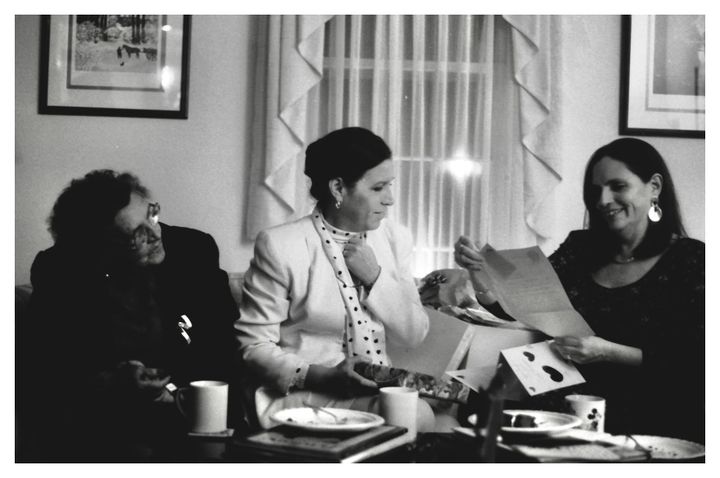 My Ecuadorian grandmother, my aunt and my mother smiling and looking at papers while I was interviewing my grandmother.