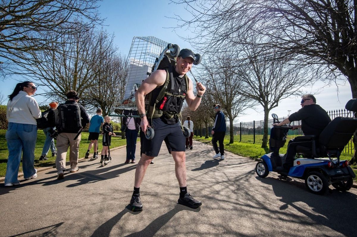 Pastor sets walking record with shopping cart on his back