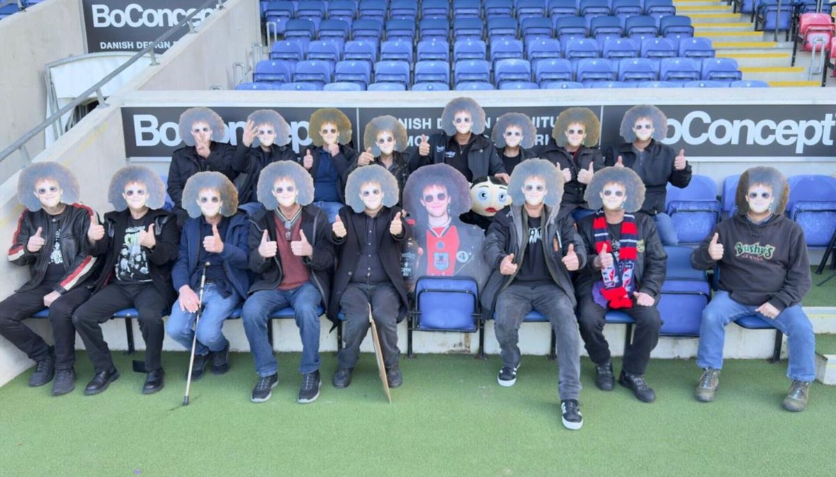 Pals wear masks of late friend’s face at football match to honor him