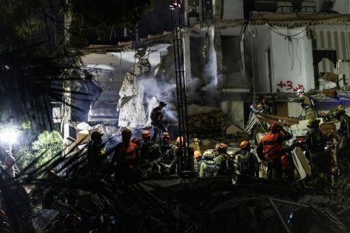 Israeli rescuers search for missing in building strike, two dead