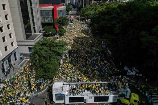 Bolsonaro son rallies the right as thousands protest Brazil government
