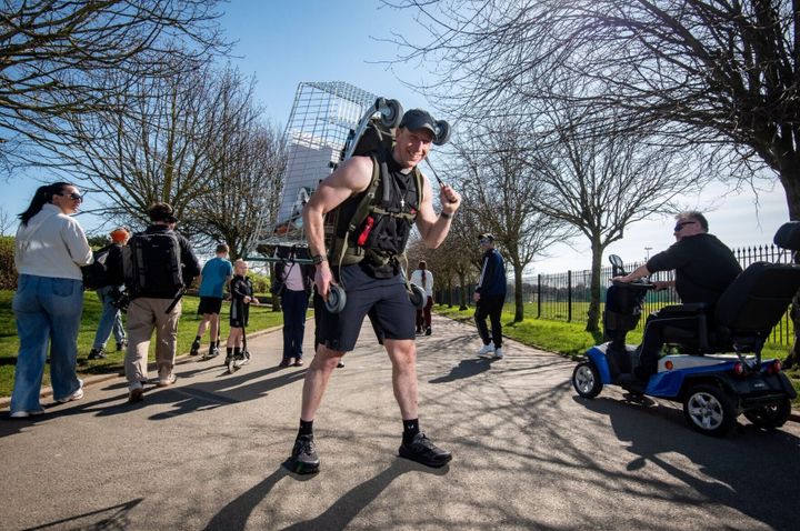 Pastor sets walking record with shopping cart on his back