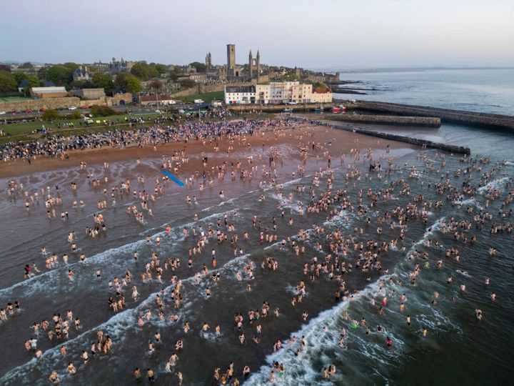 College students jump into sea for good luck on exams