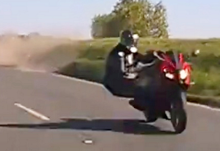 Motorcyclist narrowly avoids traffic after collision