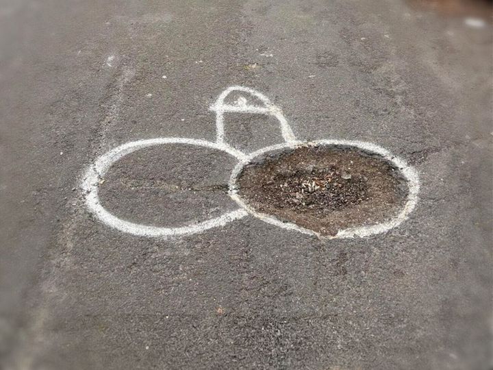 Member of community keeps spray-painting penises on potholes