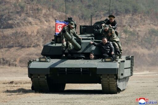 North Korean leader, daughter try out new tank