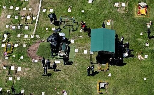 Flowers, music, and soldiers at funeral of drug lord