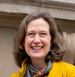 Profile picture of Lucy, a white woman with shoulder-length hair and smiling broadly.