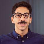 Profile picture of Eduardo, a man with light brown skin, dark hair, dark glasses, and a moustache.