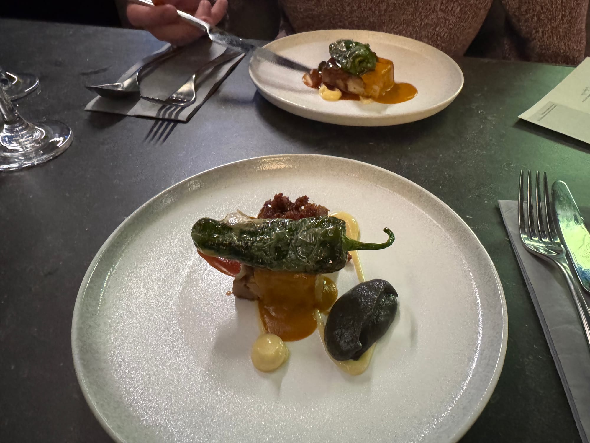 Lamb belly with Mafé Sauce, Padron pepper, aubergine and miso, bacon crumb, and jus.